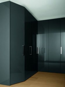A modern kitchen with sleek, dark grey sliding door wardrobes on a hardwood floor, reflecting a refined and contemporary design.
