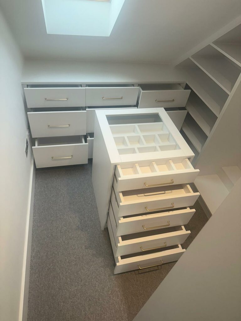 Walk-in Wardrobe with opened drawers and island