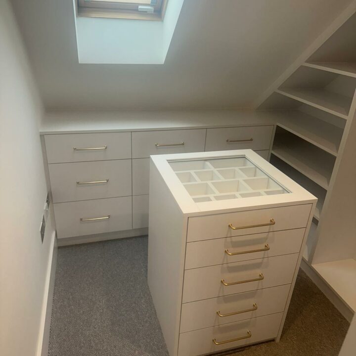 Walk-in Closet with closed drawers and cabinet isle